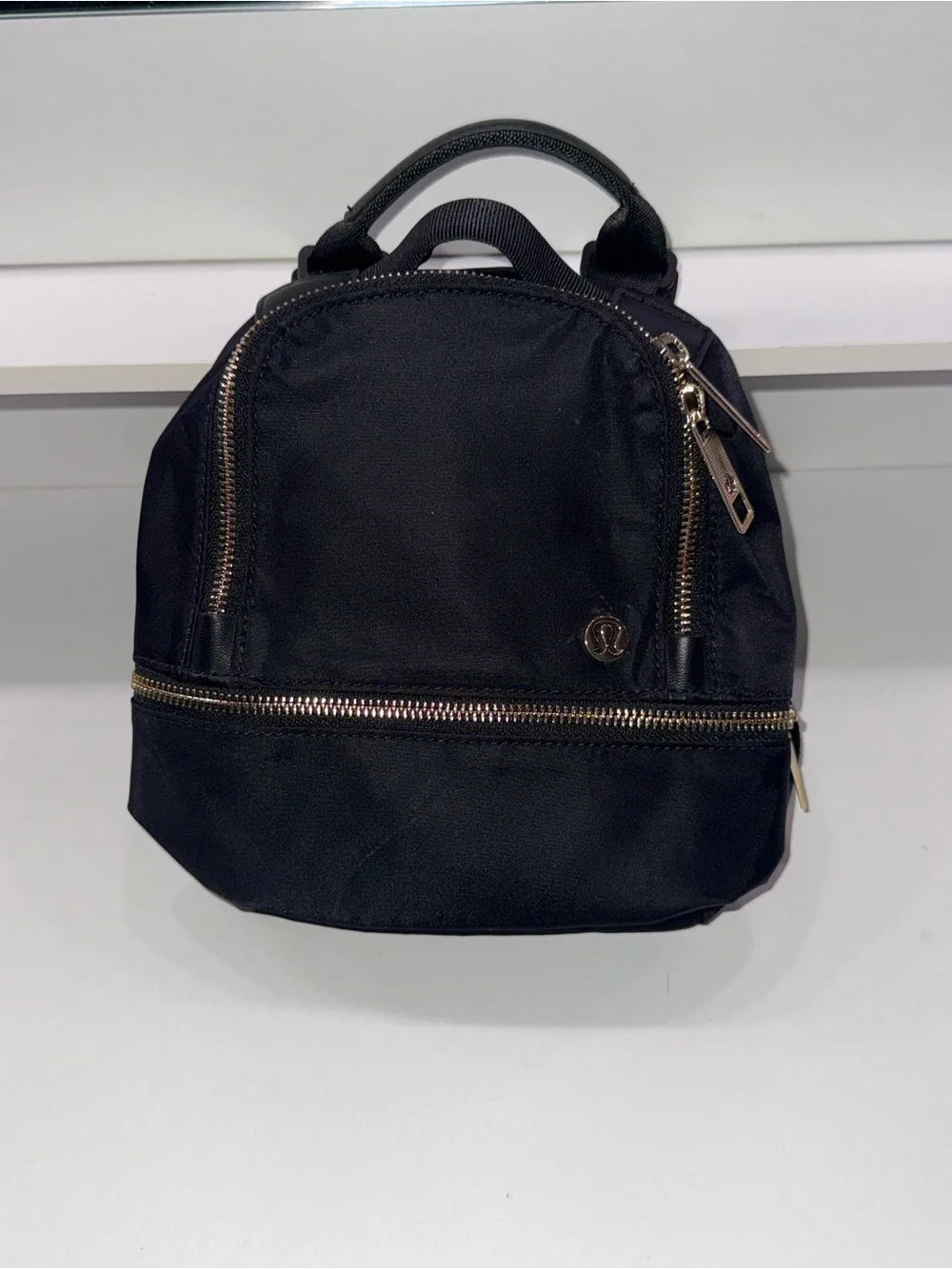 lululemon athletica Black Mini Backpack with Gold Zippers